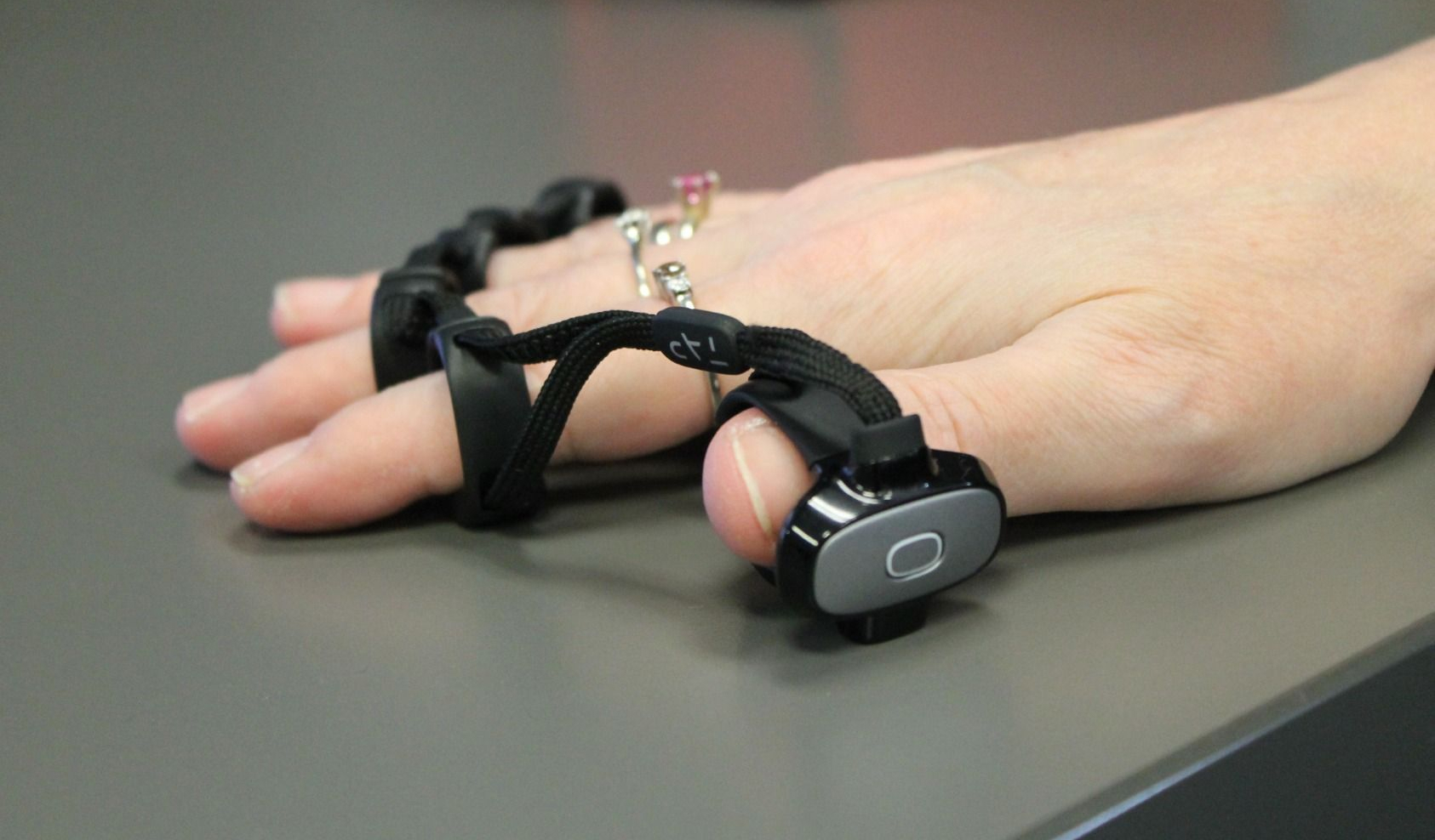 A hand wearing a virtual keyboard device