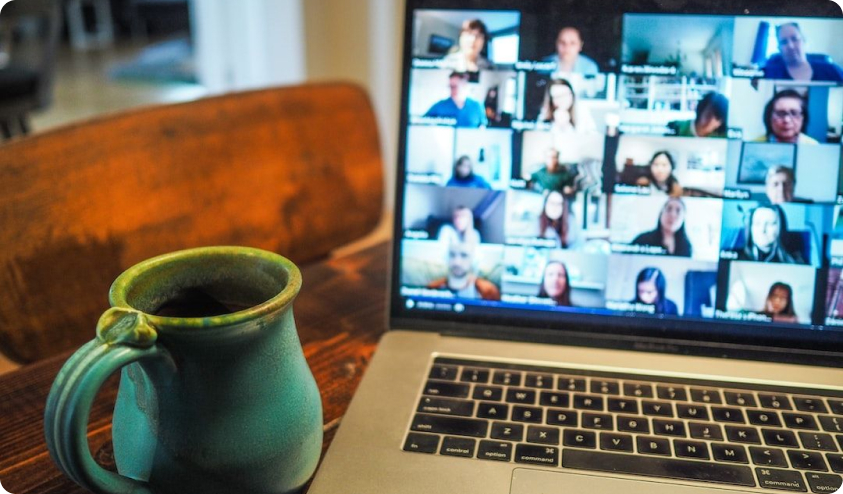 A view of a laptop with a crowded Zoom meeting grid display