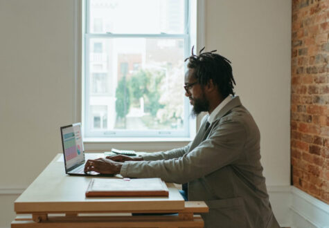 A man sits at a computer and types